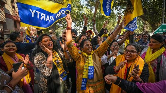 AAP supporters celebrate in Delhi after winning the MCD polls on Wednesday. (Sanchit Khanna/HT Photo)