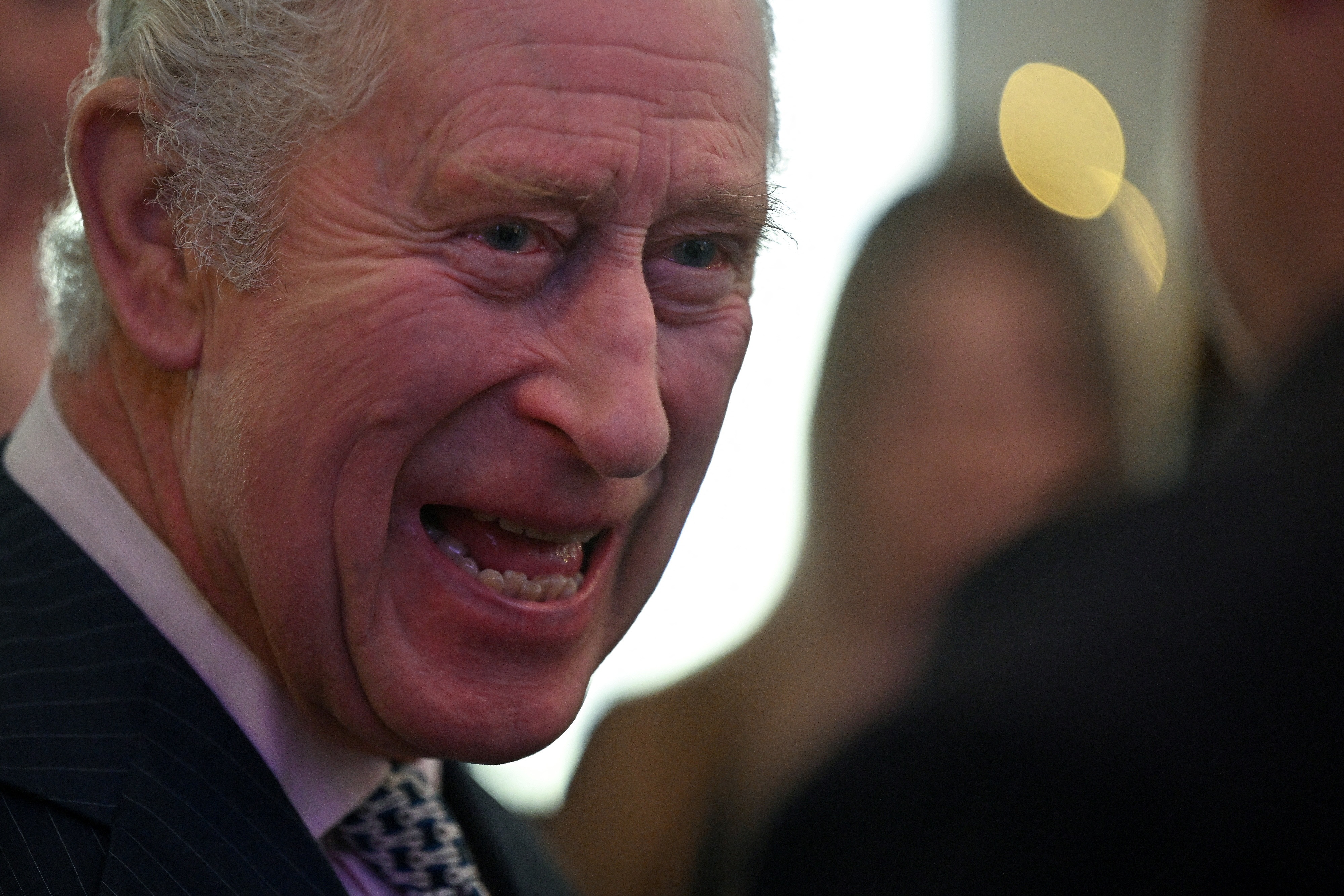 Britain's King Charles III talks with volunteers and beneficiaries of local community initiatives in King's Cross. (Reuters)