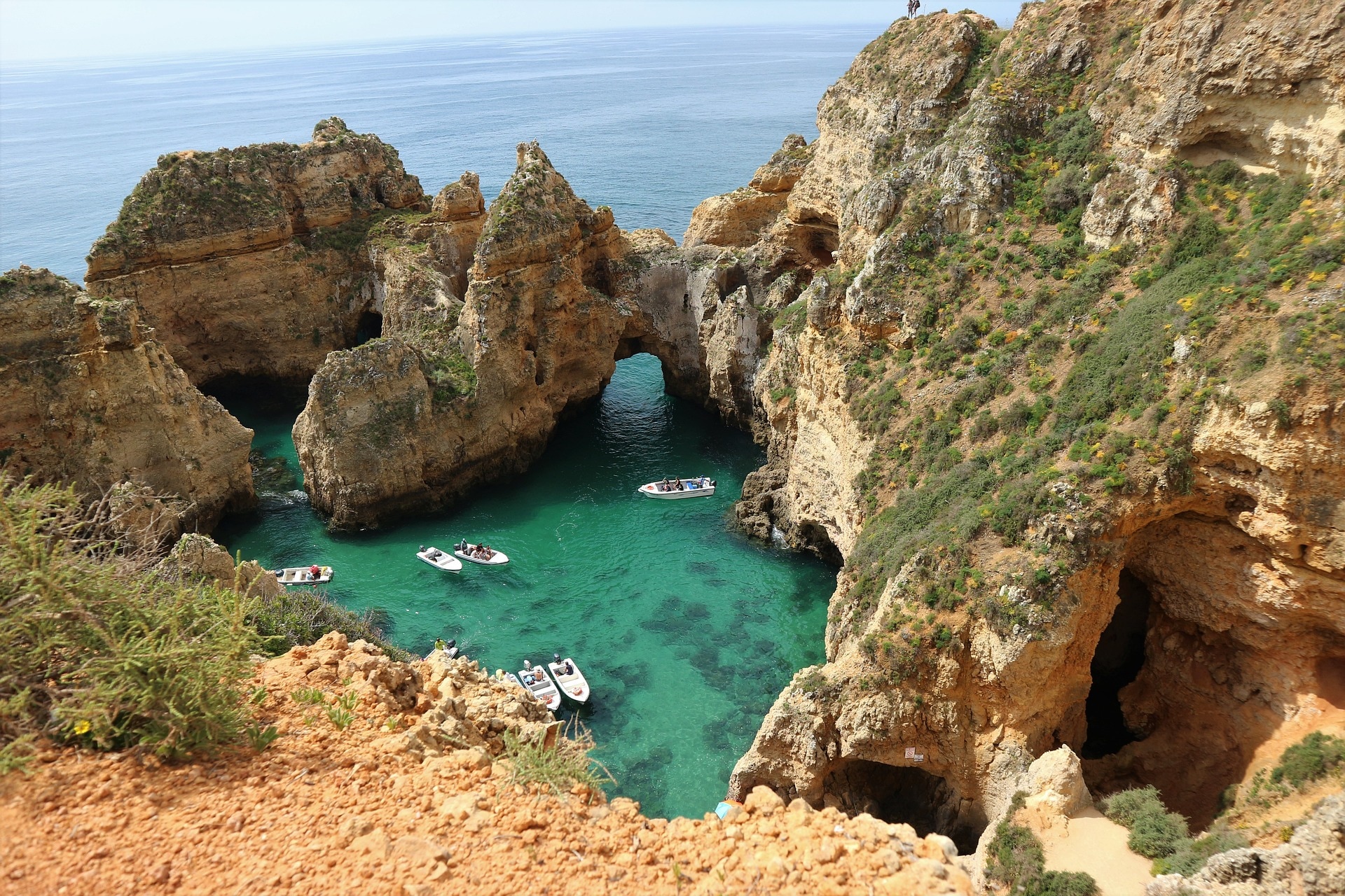 Ponta de Piedade is a picturesque location where brown-hued rock formations meet the below-surface waters of the Atlantic. (pixabay)