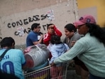 People affected by tear gas try to recover as massive crowds take to the streets in Lima, on December 8, in support of former President Pedro Castillo. Dozens voiced against his ouster by the Peruvian parliament, demanding presidential elections and the closure of Congress. (Sebastian Castaneda / REUTERS)