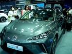 People are seen next to the MG 4 EV car at the 39 Thailand International Motor Expo, in Bangkok, Thailand, November 30, 2022. REUTERS/Athit Perawongmetha