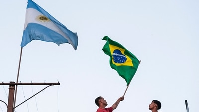 Fans of Brazil wave a Brazilian flag on the roof of their house, next to a fluttering Argentine flag, in Havana (AFP) Fans of Brazil wave a Brazilian flag on the roof of their house, next to a fluttering Argentine flag, in Havana (AFP)