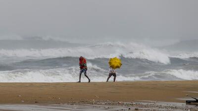 Chennai: Youngsters react as waves crash at the sea-shore ahead of the landfall of cyclonic storm Mandous, in Chennai on Friday (PTI) Chennai: Youngsters react as waves crash at the sea-shore ahead of the landfall of cyclonic storm Mandous, in Chennai on Friday (PTI)