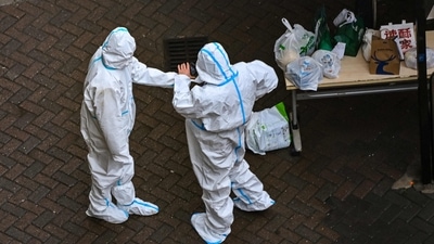 Covid In China: Security guards at the entrance of a compound under Covid-19 lockdown in the Jing'an district in Shanghai. (AFP) Covid In China: Security guards at the entrance of a compound under Covid-19 lockdown in the Jing'an district in Shanghai. (AFP)