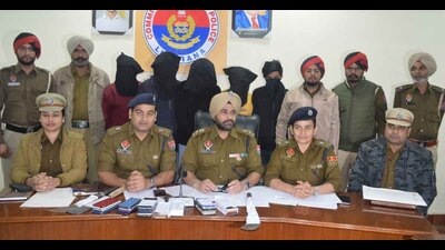 The arrested snatchers (faces covered) in Ludhiana police custody on Friday. (HT Photo)