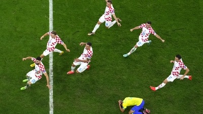 Brazil's Marquinhos is dejected after failing to score from the penalty spot as Croatia's players celebrate winning the World Cup quarterfinal between Croatia and Brazil, at the Education City Stadium in Al Rayyan, Qatar (AP) Brazil's Marquinhos is dejected after failing to score from the penalty spot as Croatia's players celebrate winning the World Cup quarterfinal between Croatia and Brazil, at the Education City Stadium in Al Rayyan, Qatar (AP)