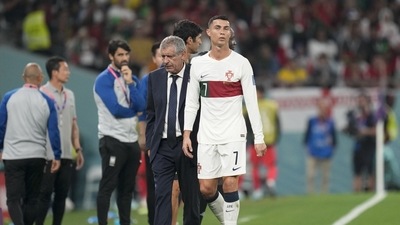 Portugal's Cristiano Ronaldo, center, passes beside his coach Fernando Santos (AP)
