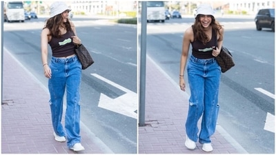 The pictures show Sharvari dressed in a dark brown printed tank top featuring a round neckline and cropped hem. She teamed it with high-waisted denim jeans that have side pockets, distressed details on the side, and a wide-leg fit. (Instagram) The pictures show Sharvari dressed in a dark brown printed tank top featuring a round neckline and cropped hem. She teamed it with high-waisted denim jeans that have side pockets, distressed details on the side, and a wide-leg fit. (Instagram)