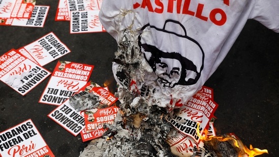 A T-shirt with Castillo's name and posters that say "Cubans out of Peru" are seen scattered during a protest on December 7, in Lima, According to AFP, Castillo's 17-month rule was overshadowed by multiple cabinet reshuffles, six investigations against him and his family, mass protests demanding his removal, and a power struggle with the opposition-backed Congress. The current crisis began as the former rural school teacher faced his third impeachment attempt since unexpectedly wresting power from Peru's traditional political elite. (Alessandro Cinque / REUTERS)