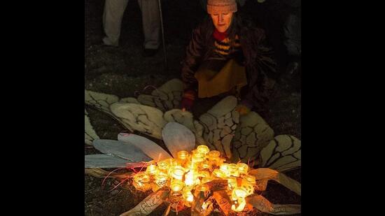 Amid candles and handwritten posts, participants share stories and raise awareness at a 2017 ceremony held in honour of extinct and endangered pollinators. (Courtesy Lost Species Day)