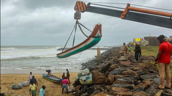 Chennai: A fishing boat being shifted to a safer place at the sea-shore ahead of the landfall of cyclone Mandous (PTI)