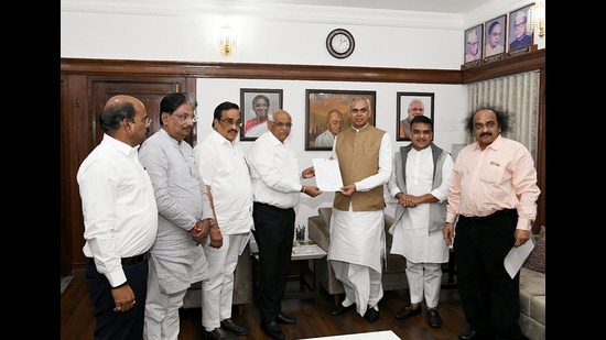 Gujarat Chief Minister Bhupendra Patel submits his resignation to State Governor Acharya Devvrat, as Bharatiya Janata Party (BJP) State chief CR Patil looks on, in Gandhinagar on Friday. (ANI Picture Service)