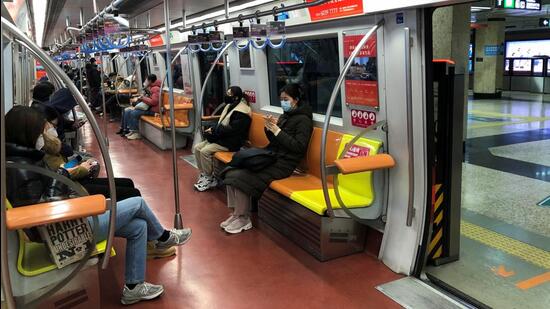 People ride on a subway during evening rush hour, after the government loosened coronavirus disease (COVID-19) restrictions, in Beijing, China. (REUTERS)