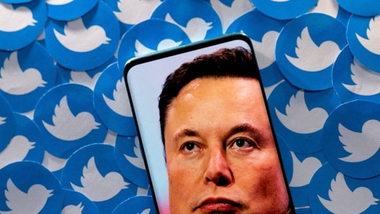 Elon Musk: An image of Elon Musk is seen on a smartphone placed on printed Twitter logos in this picture illustration.(Reuters)