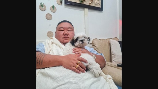 Nagaland Minister Temjen Imna Along shared this image of him with a cute dog on Twitter.(Twitter/@AlongImna)