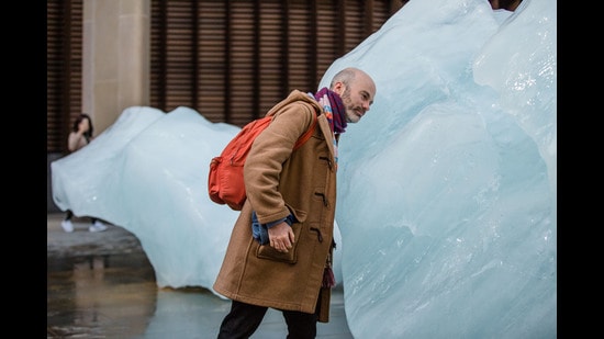 A pedestrian steps up to one of the giant blocks of glacial ice installed across London as part of a project by the Danish-Icelandic artist Olafur Eliasson in 2018. (Charlie Forgham-Bailey / Studio Olafur Eliasson))