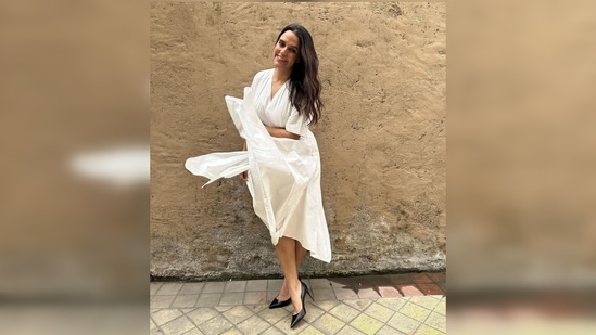 Neha Dhupia's outfit features v-neckline, loose elbow-length sleeves and an assymetrical hemline.(Instagram/@nehadhupia)