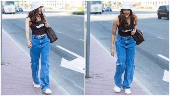 The pictures show Sharvari dressed in a dark brown printed tank top featuring a round neckline and cropped hem. She teamed it with high-waisted denim jeans that have side pockets, distressed details on the side, and a wide-leg fit.&nbsp;(Instagram)