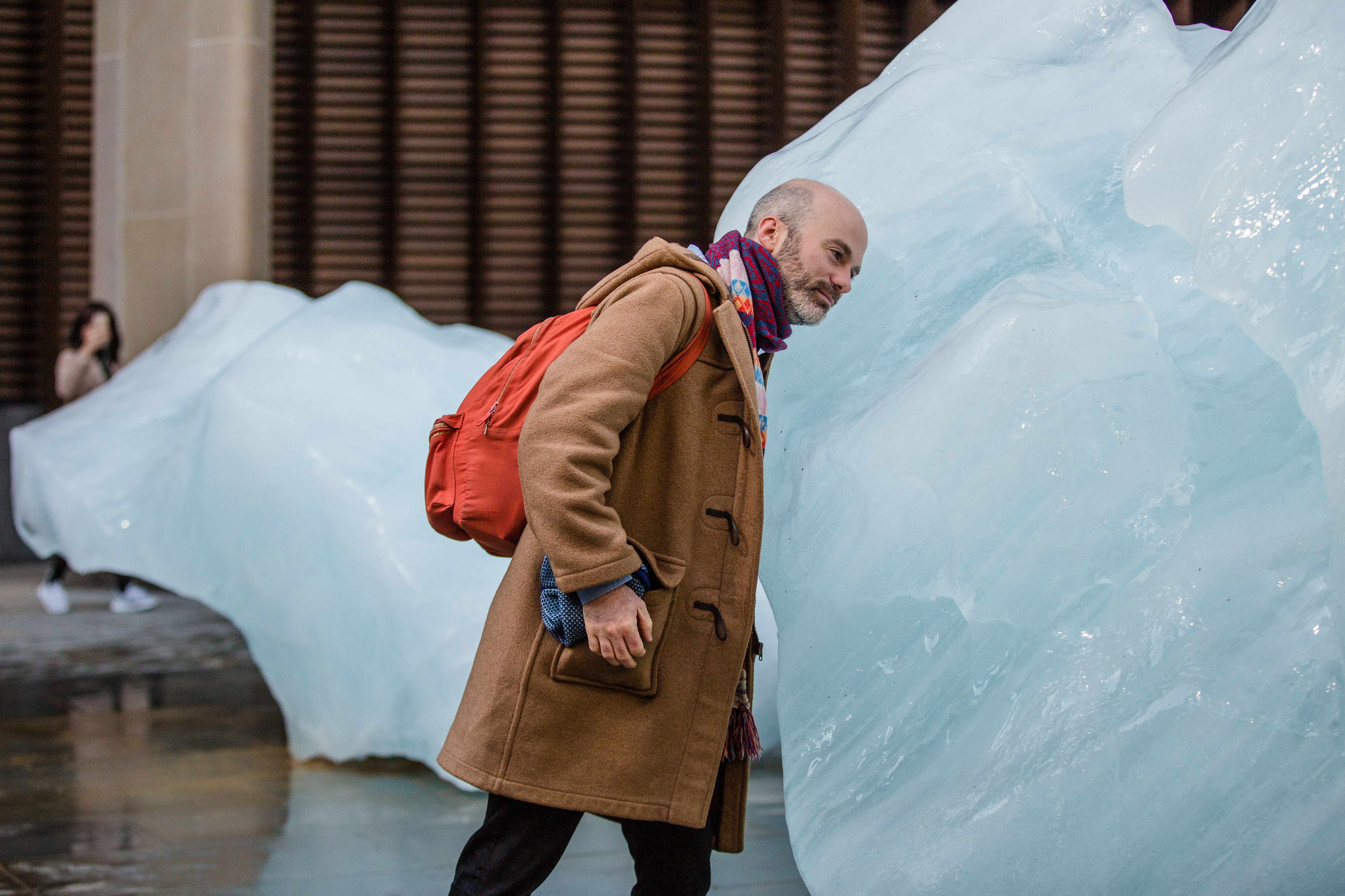 A pedestrian steps up to one of the giant blocks of glacial ice installed across London as part of a project by the Danish-Icelandic artist Olafur Eliasson in 2018. (Charlie Forgham-Bailey / Studio Olafur Eliasson)) A pedestrian steps up to one of the giant blocks of glacial ice installed across London as part of a project by the Danish-Icelandic artist Olafur Eliasson in 2018. (Charlie Forgham-Bailey / Studio Olafur Eliasson))