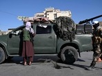 Afghanistan: Taliban fighters stand guard as they block a road near Kabul.