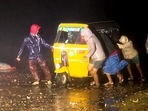 Chennai, Dec 09 (ANI): People push an autorickshaw amid heavy rain and strong winds due to cyclone 'Mandous' which is expected to cross Puducherry and Sriharikota, in Chennai on Friday. (ANI Photo)(ANI) Chennai, Dec 09 (ANI): People push an autorickshaw amid heavy rain and strong winds due to cyclone 'Mandous' which is expected to cross Puducherry and Sriharikota, in Chennai on Friday. (ANI Photo)(ANI)