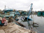 Chennai fisherman looking at damaged boats which was caused by the rainfall due to Cyclone. (PTI)