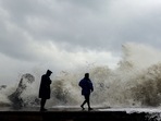 Cyclone Mandous: People stand on Kasimedu fishing harbour being hit by the high tides due to the strong winds triggered by Cyclone Mandous, in Chennai on Friday.(ANI) Cyclone Mandous: People stand on Kasimedu fishing harbour being hit by the high tides due to the strong winds triggered by Cyclone Mandous, in Chennai on Friday.(ANI)