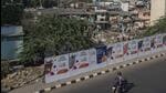 While the city is all set to host several G20 meetings from December 13 to 16, the Brihanmumbai Municipal Corporation (BMC) has put up white-coloured curtains and barricades outside the slums along the Western Express Highway (WEH). (Satish Bate/HT PHOTO) While the city is all set to host several G20 meetings from December 13 to 16, the Brihanmumbai Municipal Corporation (BMC) has put up white-coloured curtains and barricades outside the slums along the Western Express Highway (WEH). (Satish Bate/HT PHOTO)