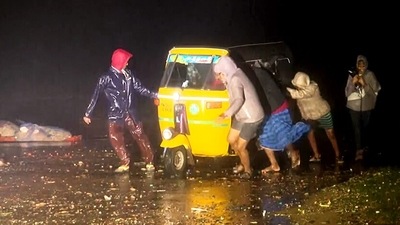 Chennai, Dec 09 (ANI): People push an autorickshaw amid heavy rain and strong winds due to cyclone 'Mandous' which is expected to cross Puducherry and Sriharikota, in Chennai on Friday. (ANI Photo) (ANI)