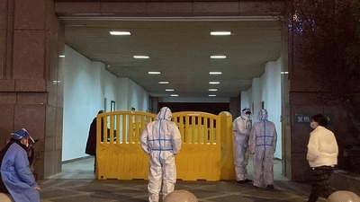 Covid In China: Workers in protective suits stand at the central hospital of Wuhan. (Reuters)