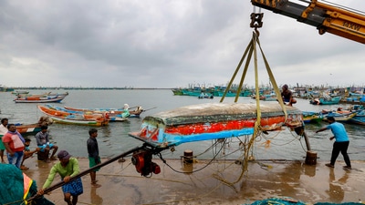 Fishermen shifting a boat at in Chennai's the Kasimedu Fishing Harbour after the cyclone's landfall. (PTI) Fishermen shifting a boat at in Chennai's the Kasimedu Fishing Harbour after the cyclone's landfall. (PTI)