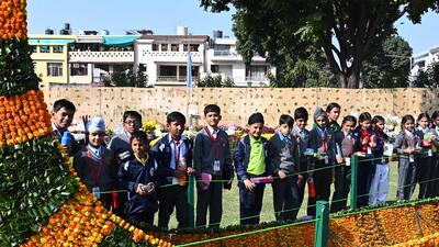 School students admiring a boat topiary at the Chrysanthemum Show at Terraced Garden in Sector 33, Chandigarh. (Keshav Singh/HT)