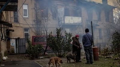 Local residents stand in the yard of their destroyed apartment building in Bakhmut, as Russia's attack on Ukraine continues, in Donetsk region, Ukraine. (REUTERS)