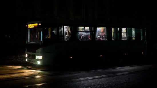 Passengers ride in a city bus down a street during a power cut in downtown Odessa, amid the Russian invasion of Ukraine. (AFP)