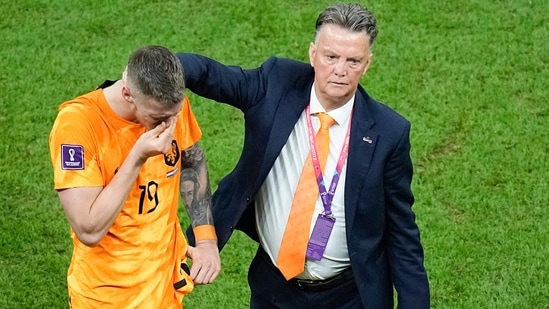 Wout Weghorst, left, is consoled by head coach and manager Louis van Gaal of the Netherlands, at the end of the World Cup quarterfinal soccer match between the Netherlands and Argentina, at the Lusail Stadium in Lusail, Qatar, Saturday, Dec. 10, 2022.(AP)