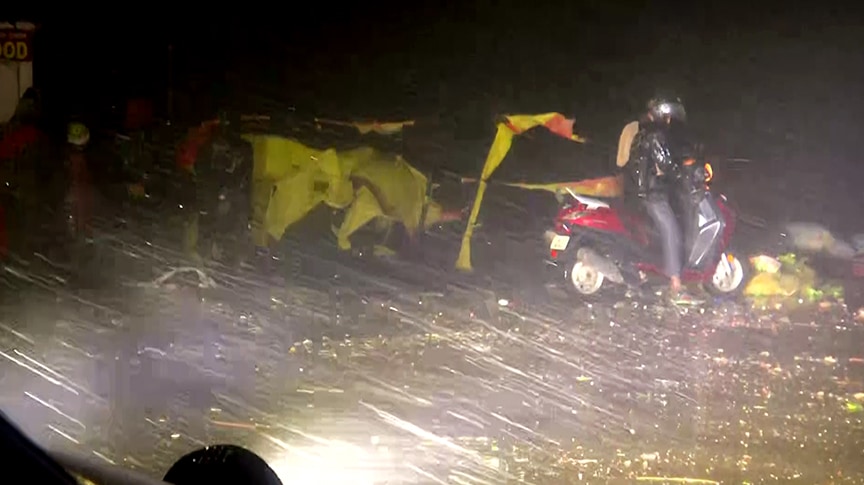 Cyclone Mandous: A man rides a scooty amid heavy rain and strong winds due to cyclone 'Mandous' in Chennai. (ANI)