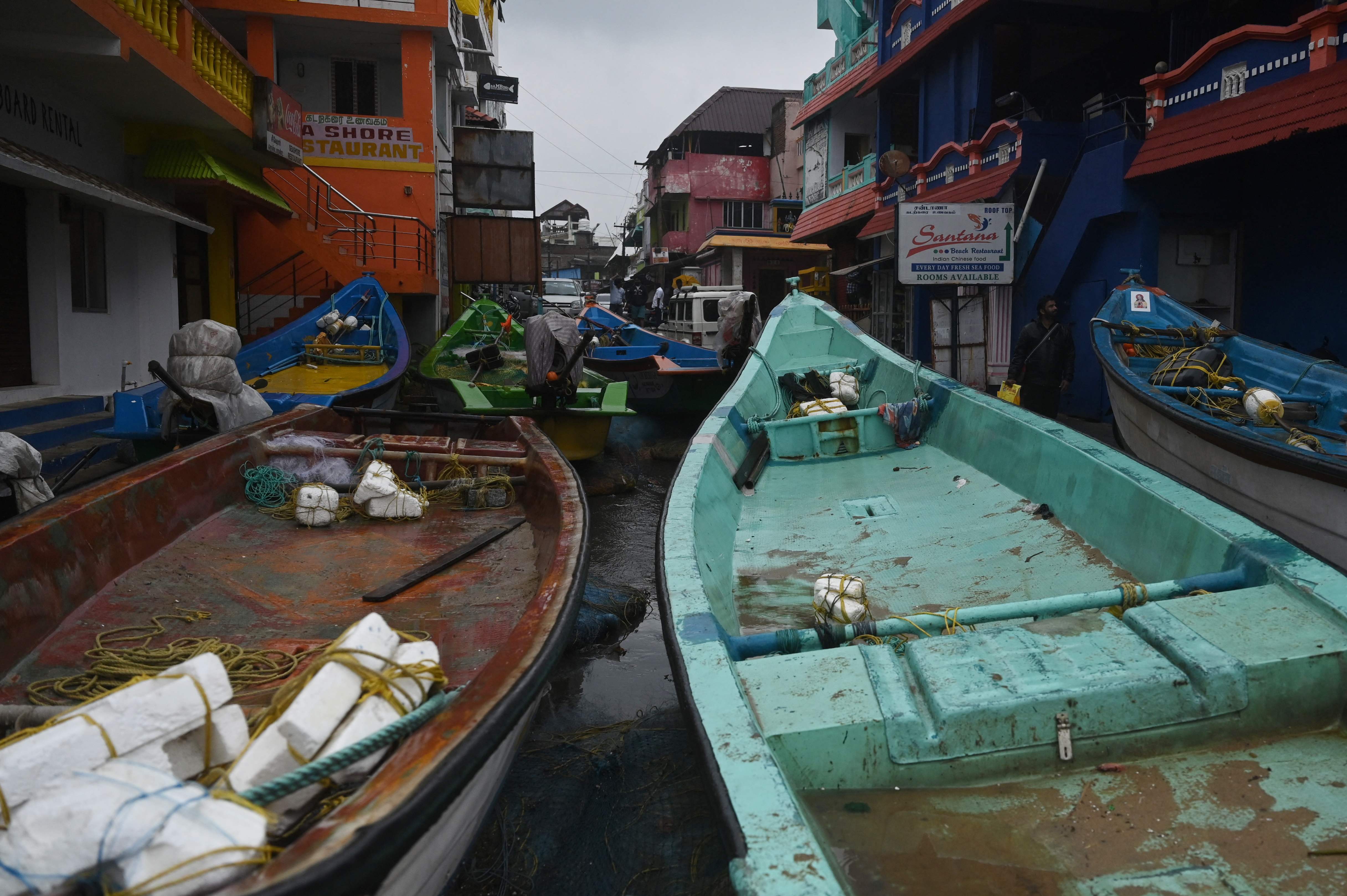 Cyclone Mandous: Fishing boats are seen stationed along a street in Mahabalipuram. (AFP)