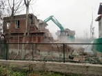 A house of the designated Jaish-e-Mohammed (JeM) terrorist Ashiq Nengroo, which is built on an encroached government land, is being demolished at the New Colony, Rajpora, in Pulwama on Saturday. (ANI Photo) A house of the designated Jaish-e-Mohammed (JeM) terrorist Ashiq Nengroo, which is built on an encroached government land, is being demolished at the New Colony, Rajpora, in Pulwama on Saturday. (ANI Photo)
