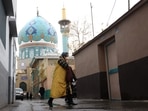 A woman walks after the morality police shut down in a street in Tehran, Iran December 6, 2022. 