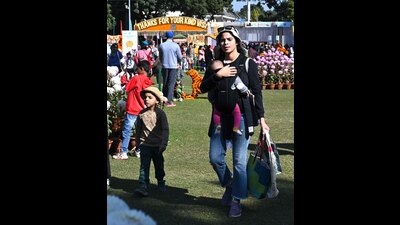 A woman and her children taking a stroll at Terraced Garden in Sector 33, Chandigarh, on the final day of Chrysanthemum Show on Sunday. (Keshav Singh/HT)