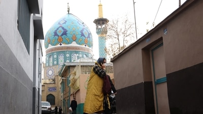 A woman walks after the morality police shut down in a street in Tehran, Iran December 6, 2022. (VIA REUTERS)