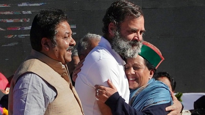 Congress leader Rahul Gandhi hugs Himachal Pradesh Congress chief Pratibha Singh as party leader Rajeev Shukla looks on, at the swearing-in ceremony of Chief Minister Sukhvinder Singh Sukhu, in Shimla on Sunday. (PTI) Congress leader Rahul Gandhi hugs Himachal Pradesh Congress chief Pratibha Singh as party leader Rajeev Shukla looks on, at the swearing-in ceremony of Chief Minister Sukhvinder Singh Sukhu, in Shimla on Sunday. (PTI)
