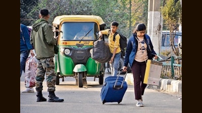 Passengers hauling their luggage after being dropped outside the Chandigarh railway station by an auto-rickshaw that needs to pay a minimum ₹30 fee to enter the station. (Sant Arora/HT) Passengers hauling their luggage after being dropped outside the Chandigarh railway station by an auto-rickshaw that needs to pay a minimum ₹30 fee to enter the station. (Sant Arora/HT)