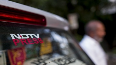Signage of the New Delhi Television Ltd. (NDTV) on a car. (Bloomberg) Signage of the New Delhi Television Ltd. (NDTV) on a car. (Bloomberg)