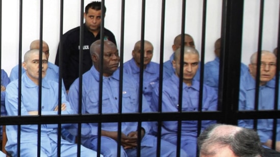 Abu Agila Mohammad Mas'ud Kheir Al-Marimi, also known as Mohammed Abouajela Masud, (2nd L) sits behind bars during a hearing at a courtroom in Tripoli November 16, 2014. (REUTERS)
