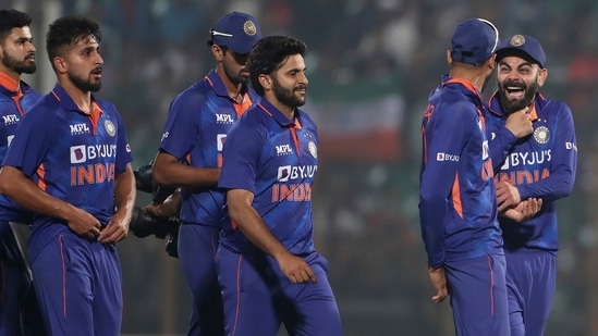 India's Virat Kohli, right, chuckle while leaving the field with his teammates (AP)