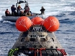 NASA's Orion capsule is drawn to the well deck of the U.S.S. Portland after it splashed down following a successful uncrewed Artemis I Moon Mission on December 11 in the Pacific Ocean off the coast of Baja California, Mexico. (Mario Tama / REUTERS)