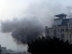 Smoke rises from a hotel building after an explosions and gunfire in Kabul, Afghanistan.