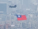 China-Taiwan Conflict: A Chinook helicopter carrying a Taiwan flag flies over the city during the country's National Day celebration in Taipei, Taiwan.