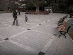 Beijing Air Pollution: A man wearing a face mask plays a ball with a child at an area used to be crowded with residents at a public park in Beijing.
